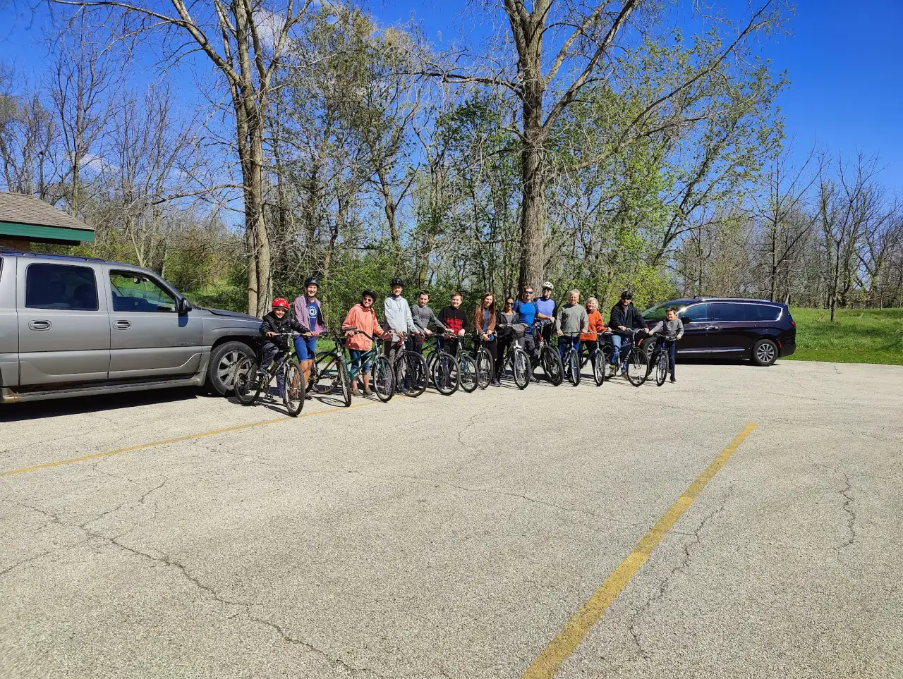 Families from Christ Fellowship Church lined up with their bikes for a church bike ride on a sunny spring day